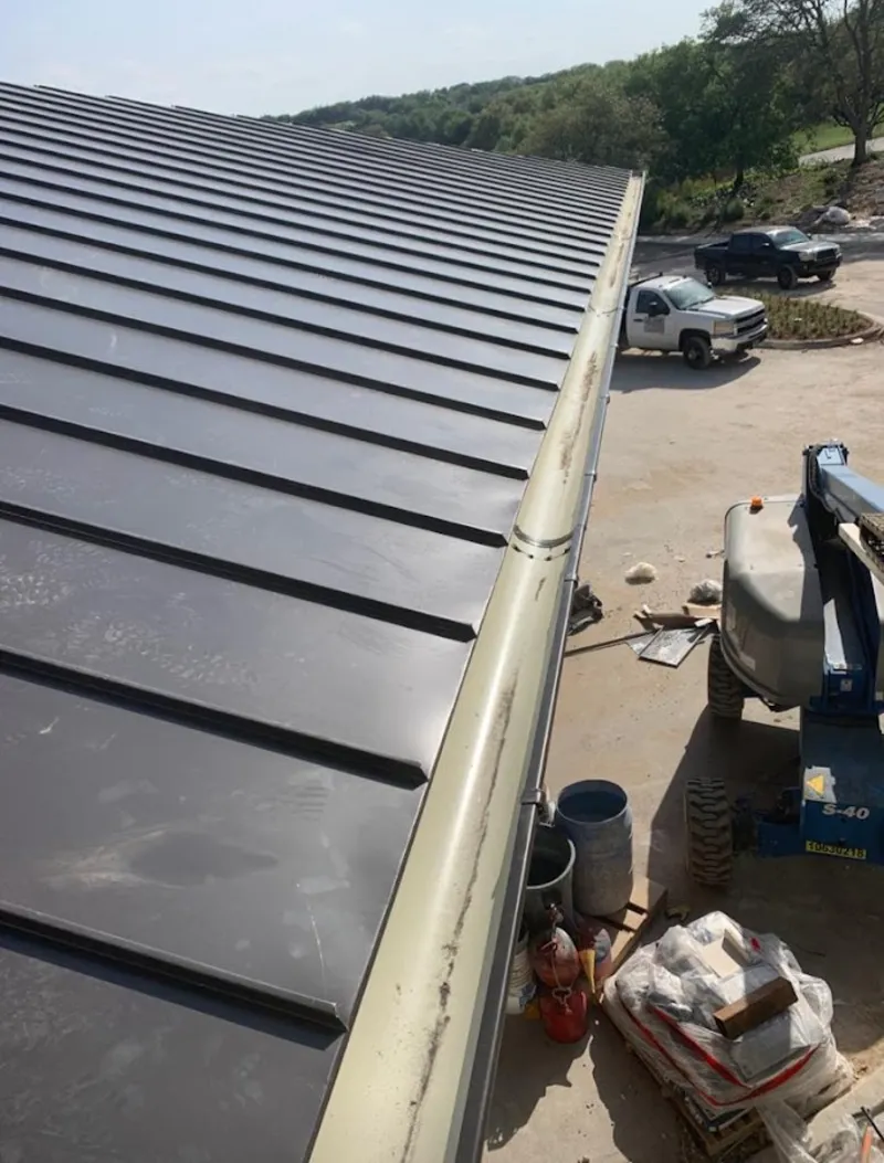 Standing seam panel and gutter detail on a metal roofing jobsite in Wayne